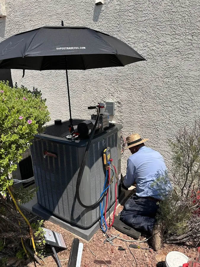 HVAC technician performing outdoor AC maintenance in Wilmington